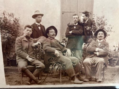 an old photo of a group of people posing for a picture at La Maison de Auguste in Coursan