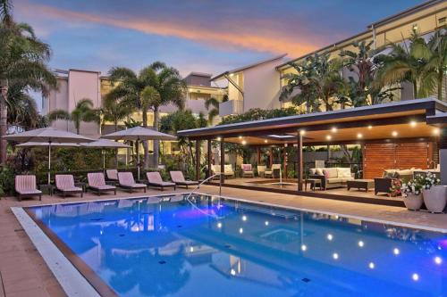 a swimming pool in front of a building at Wave Culture 1204 Beach Bliss - Apartment with complex Pool & Spa in Kingscliff