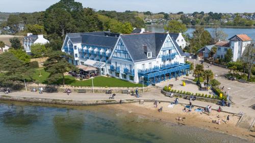 an aerial view of a large blue and white house on the beach at Best Western Plus Le Roof Vannes Bord de Mer in Vannes