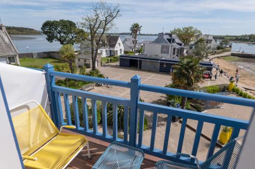 a balcony with a blue railing and a yellow chair at Best Western Plus Le Roof Vannes Bord de Mer in Vannes