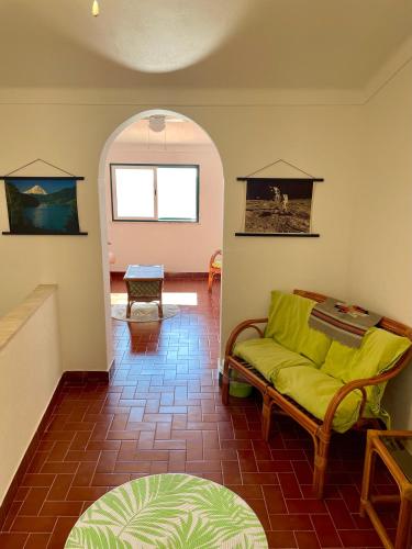 a living room with a yellow couch and a table at Casa David in Castelo de Vide