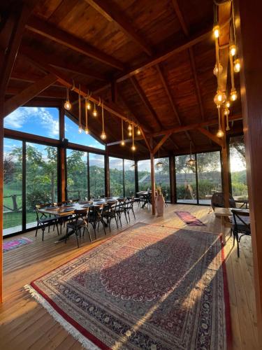 a large room with tables and chairs and windows at Bujtina Ajazi in Golem