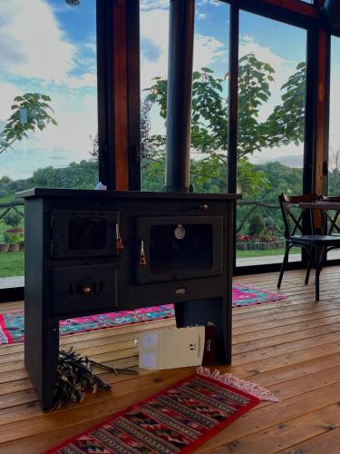 a wood stove sitting on top of a wooden floor at Bujtina Ajazi in Golem