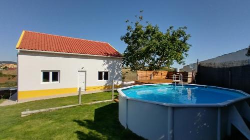 a house with a large tub in the yard at Casa da Caroleira in Paços