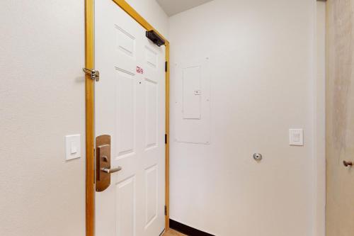 a door leading to a room with white doors at Aspen Suites 506: The Nest in Leavenworth