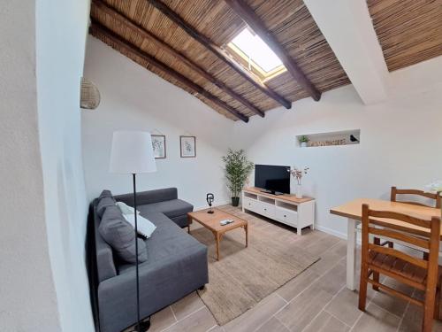a living room with a couch and a table at Typical house in Algarve 5m from beach in Porches
