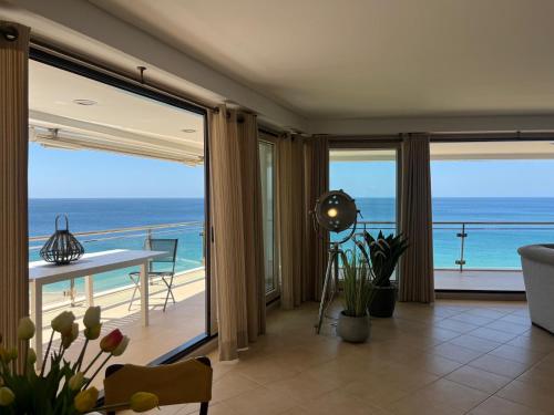 a living room with a view of the ocean at Belle vue Sesimbra in Sesimbra