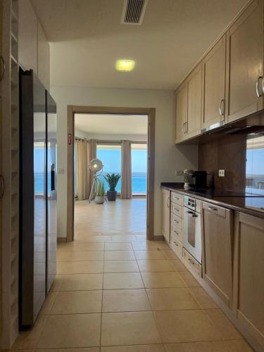 a large kitchen with a view of the ocean at Belle vue Sesimbra in Sesimbra