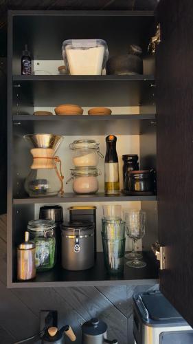 a kitchen cabinet filled with lots of food items at Paradise Ranch Inn- Awake House Hot Tub,Sauna in Three Rivers