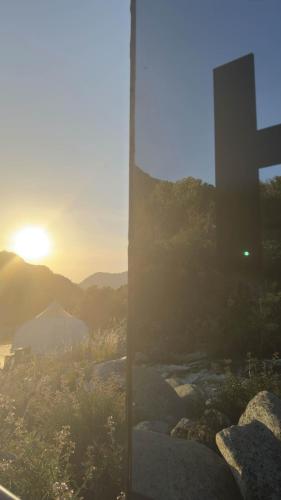 a cross on a hill with the sunset in the background at Paradise Ranch Inn- Limitless House Hot Tub,Sauna in Three Rivers