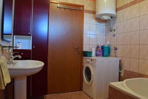 een badkamer met een wasmachine en een wastafel bij Apartment in Risika - Insel Krk 50492 in Risika