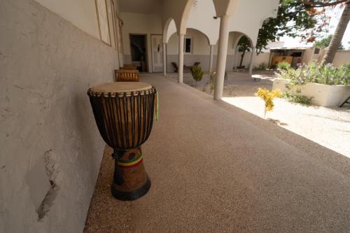 a drum sitting on the side of a building at La Teranga Toubacouta in Bani
