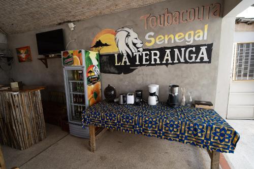 a table in a room with a sign on the wall at La Teranga Toubacouta in Bani
