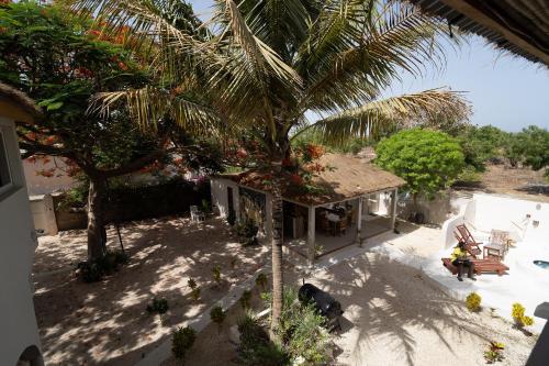 an overhead view of a house with a palm tree at La Teranga Toubacouta in Bani