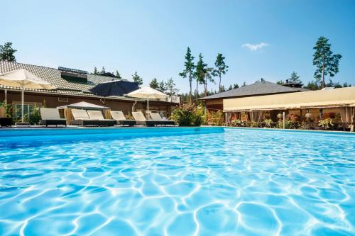 a swimming pool in front of a hotel at Seasons SPA Boutique Hotel in Kozin
