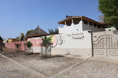 a white wall with a painting of a horse on it at La Teranga Toubacouta in Bani