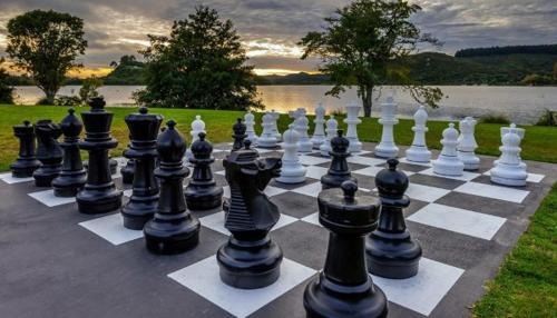 a giant chessboard is lined up on a lawn at VR Rotorua Lake Resort in Rotorua