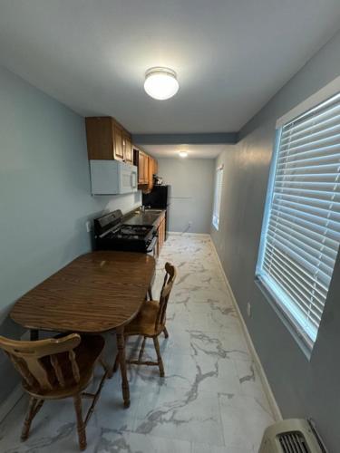 a kitchen with a table and chairs in a room at Hammock Inn & Suites North Beach Hotel in Seaside Heights
