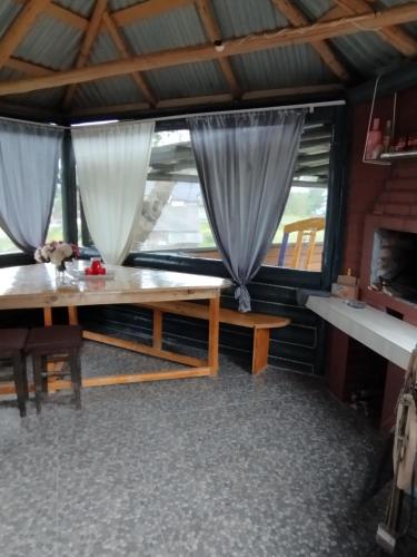 a room with a table and a window with curtains at У Ондраша in Yasinya