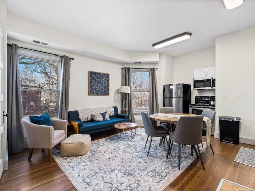 a living room with a blue couch and a table at Carriage Manor - Sun Soaked 1BR - Close to CCF in Cleveland