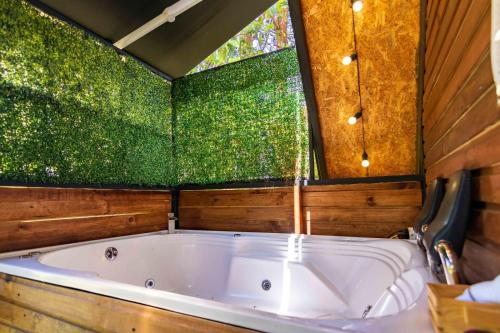 a large bath tub in a room with a window at EUCALYPTO CHALET in Guarne