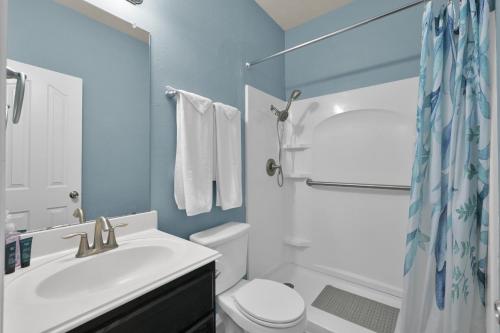 a bathroom with a sink and a toilet and a shower at Peace, serenity and relaxation on the lake in Conroe