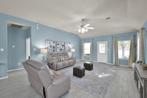 a living room with blue walls and a couch at Peace, serenity and relaxation on the lake in Conroe