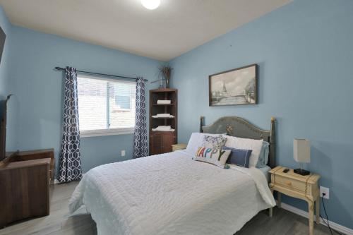 a blue bedroom with a bed and a window at Peace, serenity and relaxation on the lake in Conroe