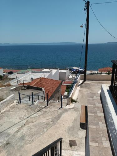 a view of the ocean from the balcony of a building at Seaview studio in Neapolis