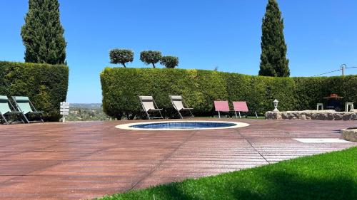two chairs and a fire pit in a garden at Eco Natura Falcoeira - Praia da Luz in Montinhos da Luz