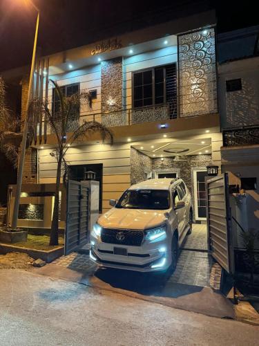 a white truck parked in front of a house at Vip homes jhelum in Jhelum