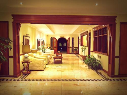 a living room with a couch and a table at Sovereign Hotel in Kisumu