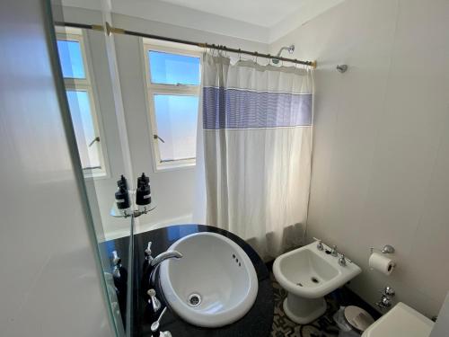 a bathroom with a sink and a toilet and a shower at Recoleta Luxury Apartment in Buenos Aires