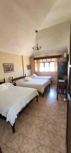Una cama o camas en una habitación de Hotel Carmen