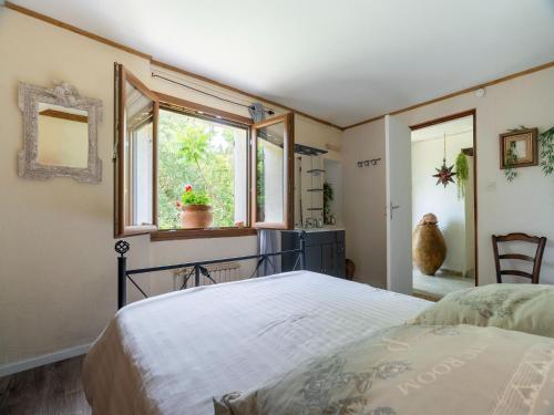 a bedroom with a bed and a window at Majestic holiday home in Laroque with hot tub in Laroque
