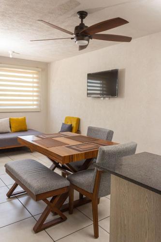 a dining room table with chairs and a ceiling fan at Central apartment near IMSS, H. Civil and CUCS in Guadalajara
