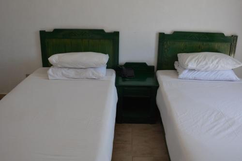 two beds sitting next to each other in a room at Morgenland Holly Village in Saint Catherine