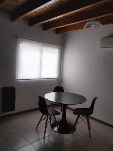 a table and chairs in a room with a window at Cómodo Departamento 2 Ambientes in Guaymallen