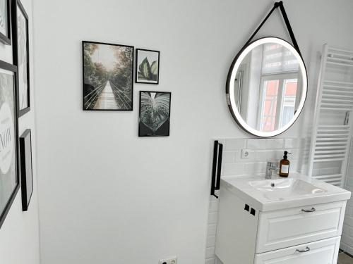 a bathroom with a mirror and a sink at SecretApartment: Fewo in Warburg in Warburg