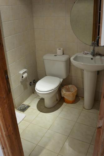 a bathroom with a toilet and a sink at Morgenland Holly Village in Saint Catherine