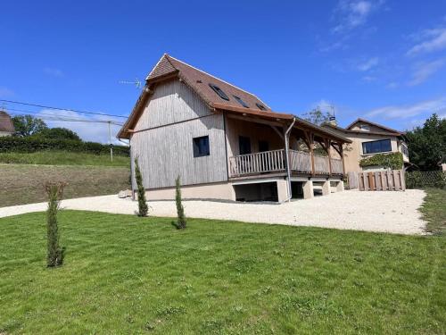 a large house with a porch and a balcony at Maison moderne avec WiFi, animaux admis, parking et climatisation en Périgord Vert - FR-1-616-337 in Preyssac-dʼExcideuil