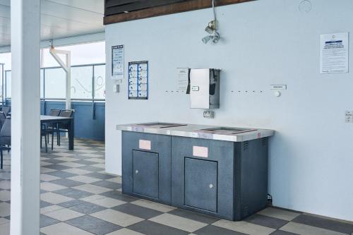 a kitchen with a counter in a room with a table at Centrepoint Apartments Caloundra in Caloundra