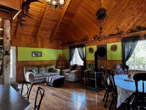 a living room with a couch and a table at Le Chadou in Tadoussac