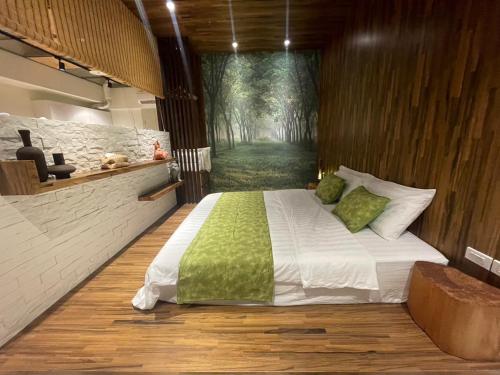 a bedroom with a bed with a painting of a forest at 光嶼海溫泉海景無邊際泳池豪華套房 in Hsin-hsing