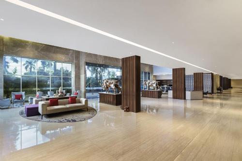 a lobby with a couch and chairs in a building at Swiss-Belinn Modern Cikande in Serang