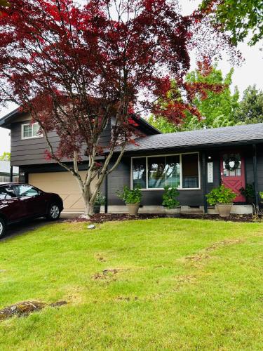 a house with a car parked in front of it at Emerald City 3 Bedroom 1 bath Home in Eugene