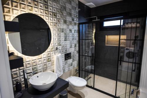 a bathroom with a toilet and a sink and a shower at Gökova Nergis Evleri in Milas