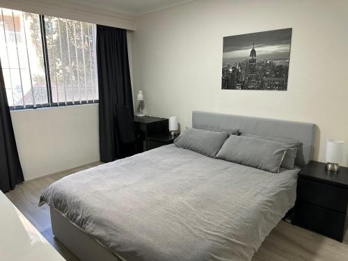 a bedroom with a bed and a desk in it at Resort Style 2BR Apt in Pyrmont Next to Darling Harbour in Sydney