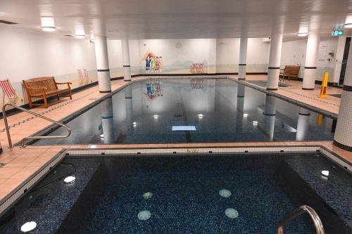 a large swimming pool in a building at Resort Style 2BR Apt in Pyrmont Next to Darling Harbour in Sydney