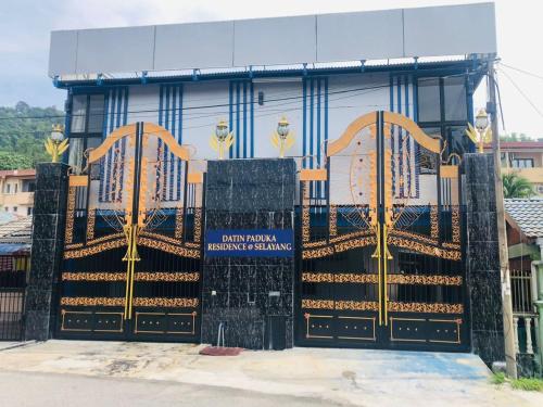a gate in front of a building with gold gates at DP Residence SELAYANG in Batu Caves